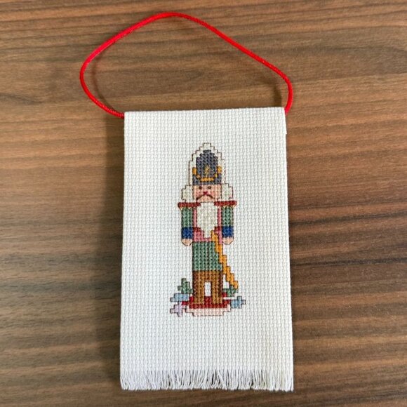 Vintage Handmade Cross-Stitch Nutcracker Ornament With Red Hanging Loop - Picture 2 of 7